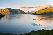 Fjord Fuglafjordur and Leirviksfjordur at sunset, in the background the mountains of the island Kalsoy. The island Eysturoy one of the two large islands of the Faroe Islands in the North Atlantic. Europe, Northern Europe, Denmark, Faroe Islands.