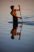 Fisherman in Taungthaman Lake near U Bein Bridge, Amarapura, Mandalay, Myanmar
