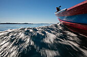 Low-angle view of water spray from longtail boat during excursion to Maung Shwe Lay village, near Ngapali, Thandwe, Myanmar