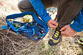 Climbers lace up climbing shoes