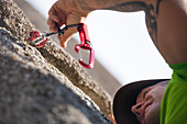 Climber putting cams while climbing