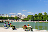France, Paris. 1st arrondissement. Jardin des Tuileries. Parisians sun bathing.