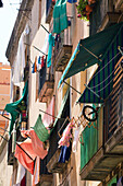 Spain, Catalonia, Barcelona, El Raval area, Carrer de Sant Bartomeu, laundry drying at windows