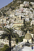 Italy, Amalfi coast,Positano, panorama on the old village of fishermen with the church Santa Maria assunta and his covered dome of glazed tiles, near the beach