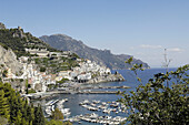 Italy, Amalfi Coast, Amalfi is a small Spanish-looking town whose high white houses are perched on the slopes of the hills in front of a deep blue sea. Marina in the foreground