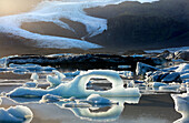Ice arch among icebergs floating on Fjallsarlon lagoon, near Jokulsarlon, South Iceland, Polar Regions