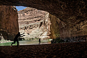 Two Men play pass in a cave in the Grand Canyon