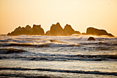Scenery with waves and rock formations in sea at sunset, Bandon Beach, Oregon, USA