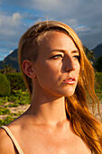 Portrait with headshot of young woman with long blonde hair, Kauai, Hawaii, USA