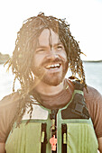 Humorous photograph of man with seaweed wig, Portland, Maine, USA