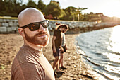 Fotografieren Sie mit Selfie des jungen Mannes in der Sonnenbrille mit Bart und Schnurrbart auf Strand, Casco-Bucht, Portland, Maine, USA.