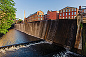 Motala Stroem with waterfalls flowing through the former industrial landscape Norrkoepings, Sweden