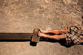 Legs of man laying on crucifix