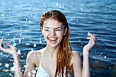 Caucasian woman splashing in ocean