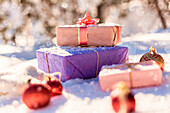 Christmas gifts and ornaments in snow