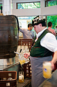 Pouring beer at the beer garden at the Chinese Tower in the English Garden, Munich, Bavaria