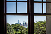 view of manhattan and one world trade center from a window in the main building on ellis island, museum of immigration immigration, new york harbor, new york city, state of new york, united states, usa
