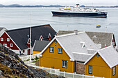 colorful houses in front of the astoria cruise ship,  city of nuuk, greenland