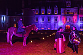 horses and a troubadour welcoming the spectators with music, chateau de maintenon fabulous christmas spectacle, with the participation of 800 volunteers, eure-et-loir (28), france