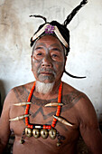 Naga man, Nokphong Wangpen, head hunter, with chest tattoo marking him as having taken a head, and Naga necklace, Nagaland, India, Asia