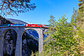 Bernina Express train on Landwasser Viadukt, UNESCO World Heritage Site, Filisur, Albula Region, Canton of Graubunden, Switzerland, Europe