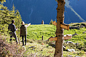 Hikers on Sentiero del Carbonaio, San Romerio Alp, Brusio, Poschiavo Valley, Canton of Graubunden, Switzerland, Europe