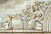 France, Gironde, Castillon-la-Bataille, allegorical bas-relief depicting the wine-producing craft on the front of a wine-warehouse