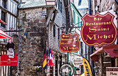 Normandy, Mont Saint Michel, signs in the main street, (UNESCO World Heritage) (on the way to Santiago de Compostela)