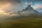 View of landscape and winding road from Marmolada Pass at sunset, South Tyrol, Italian Dolomites, Italy, Europe