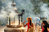 Burning incense at Po Lin Monastery, Ngong Ping, Lantau Island, Hong Kong, China, Asia