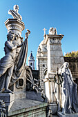Statues at the entrance to vaults in La Recoleta Cemetery, which lies right in the heart of the city, Buenos Aires, Argentina, South America