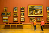 Tourist viewing 19th century Russian paintings, Russian Museum, UNESCO World Heritage Site, St. Petersburg, Russia, Europe