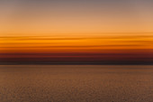 Scenic view of sea against orange sky during sunset