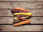 Directly above shot of various carrots on wooden table