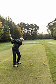 golf player teeing off on a golf course near Hamburg, north Germany, Germany