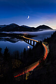 lighttrails of cars crossing the Faller-Klamm-bridge at the Sylvensteinspeicher, Lenggries, Bavaria, Germany