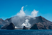 Steam rises from the craggy landscape of New Zealands only volcanic Island, White Island, Bay of Plenty, North Island, New Zealand