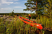 Family is on the canoe on Vaenersee Torsoe Island near Mariestad, Vänernsee, Sweden