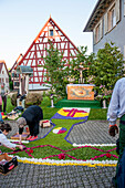 Men and woman arranging petals on the floor, Corpus Christi, Feast of Corpus Christi, procession, Sipplingen, Lake Constance, Baden-Wuerttemberg, Germany, Europe