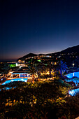 Hotel pool and garden at night, Agia Galini, Crete, Greece, Europe