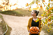 Girl with pumpkin on Halloween, Hamburg, Germany