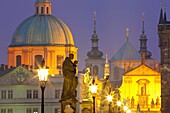 Czech republic prague - charles bridge and spires of the old town at dusk.