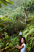 FRENCH POLYNESIA, Moorea. Laurel and her kds going for a morning hike.