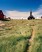 GREENLAND, Ilulissat, Disco Bay, exterior of church with field