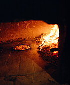 ITALY, Siena, Castello Di Spannochia, cooking pizza in stone oven