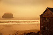 USA, Oregon, Pacific City, a foggy morning view of Pacific City beach looking out at a large rock in the distance