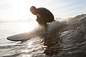 Surfer Riding A Wave Near Homer, Southcentral Alaska, USA