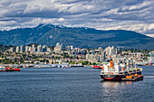 Cargo ships in the Vancouver harbour; Vancouver, British Columbia, Canada