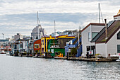 The Fisherman's Wharf tourist attraction with colourful floating homes and cottage rentals in Victoria Inner Harbour on Vancouver Island; Victoria, British Columba, Canada