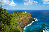 A lighthouse and trail along a ridge with steep cliffs on the coastline of the Island of Hawaii; Kilauea, Island of Hawaii, Hawaii, United States of America
